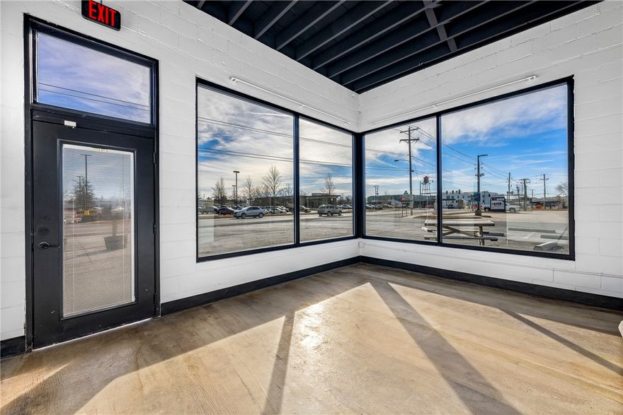 Endless possibilities await at this prime location! Situated directly across from Harp’s and just a block from Locust St (Hwy 12), this C2-zoned corner lot boasts incredible visibility and a high-traffic count—ideal for a wide range of businesses or a smart investment opportunity.
Plus, the Razorback Greenway is less than half a block away, providing seamless access to the trail system. As a bonus, recent upgrades include a brand-new roof and office windows, thanks to repairs from the May '24 tornado. Don't miss out on this high-exposure, high-potential space!