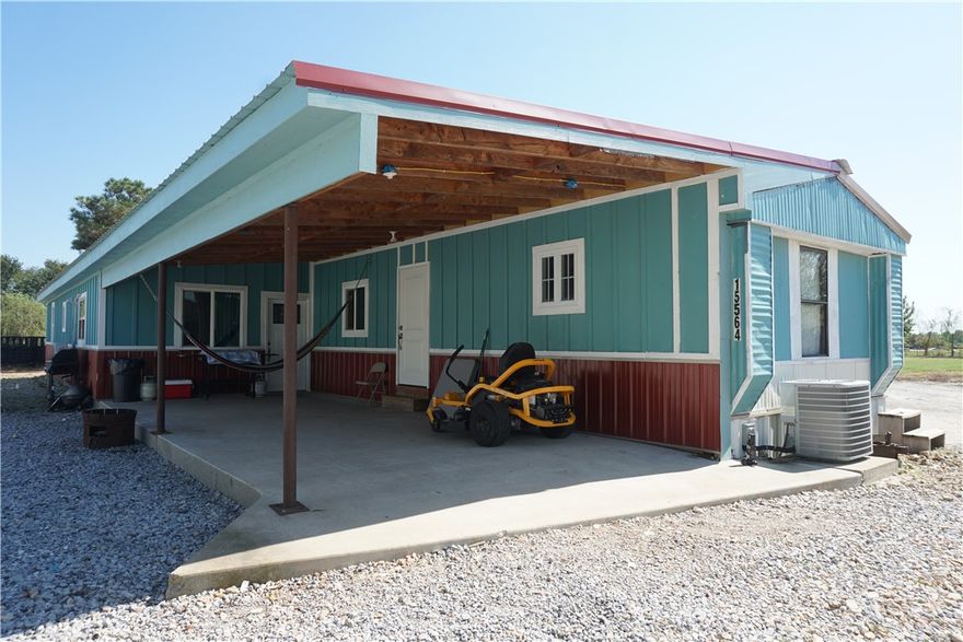Just a 2 minute drive from 412 and 20 minutes from Springdale, this spacious mobile home with adjoining workspace, 50x22 Shop building, and 2nd trailer would be a great investment. Just outside of Siloam Springs city limits, this 1 acre lot is brimming with potential. 

The main trailer at 15564 has 560sqft large modern addition added 4 years ago with a 442sqft covered porch. Adjoining it to the south, there is a long sheet metal building with cement floors. 

Further south, the large red shop building was built in 2022 and has a large roller door for storage. To the North at the entrance of the property there is a 3 Bed 2 Bath trailer at 15562 that needs work but is currently rented month to month at $550.