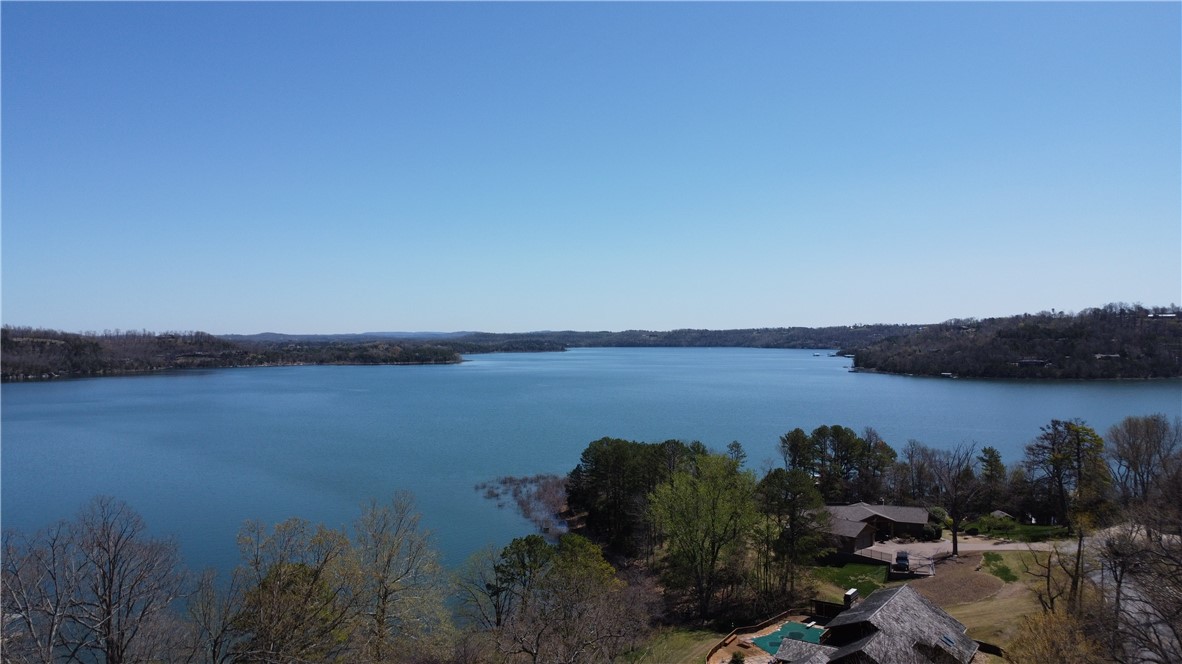 Who is looking for a great building lot with an awesome lake view? This might just be the one! This 0.56 acre lot is located 17 minutes east of Downtown Rogers in the well established Runnymede Neighborhood. The land itself is sloped but build your dream house near the top & that will give you one heck of a view. The owner had the property surveyed with all the boundaries marked, had a soil percolation test, with the test results allowing for a 4 bedroom home, and had a septic design completed. The owner even had custom house plans drawn up & those can be available as well! Please take a drive out and see if it's meant to be!