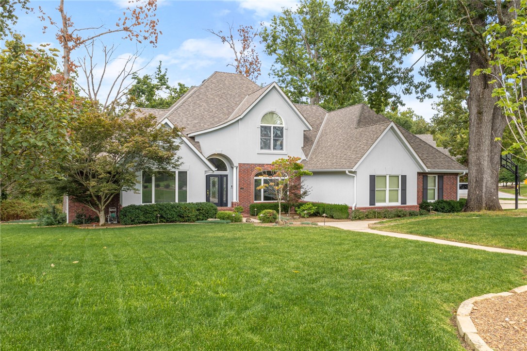 Charming Stonehenge Estate home nestled in a park-like setting just off of Walton Boulevard. This home is all about craftsmanship, access and amenities! Stonehenge is 2.5 miles to downtown Bentonville and 2.5 miles to I-49. Upgrades include new roof, downstairs hardwood flooring throughout, renovated fireplace with built-ins in living area, full kitchen and primary ensuite renovation, 1 HVAC unit is new and 1 water heater is new. Floorplan offers formal dining room, library/office, private primary suite, spacious bedrooms, hearth room, ample storage and a 3 car garage of your dreams!