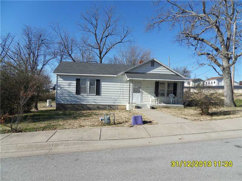 Charming 2 bedroom, one bath home that could made into 3 bedroom. This one has a storm cellar you can get to from inside the house and was taken care of. House sits on almost a half acre lot and is directly across the street from the school. Would make,a nice starter home or a rental. Besides tub in bathroom, previous owner had shower with door installed in master bedroom.
