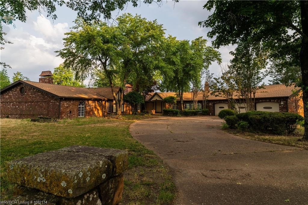 Welcome to 3655 Beach Way in Van Buren, AR- a rare and remarkable estate set on 112+/- acres of beautiful cross-fenced pastureland only minutes from town. With more than 5,900 sqft of living space, this custom home features 3 bedrooms, 3.5 bathrooms, and an attached 3-car garage. The property boasts a private in-ground pool, 3 ponds, multiple barns, large workshop, horse stables, and a covered training arena- all framed by sweeping scenic views. Whether you're dreaming of a sustainable lifestyle or an expansive working ranch, this property offers endless possibilities. There is ample space to grow vegetables, raise cattle, train horses, and fully embrace the farming or ranch life. A perfect blend of luxury, functionality, and freedom-this is country living at its finest.