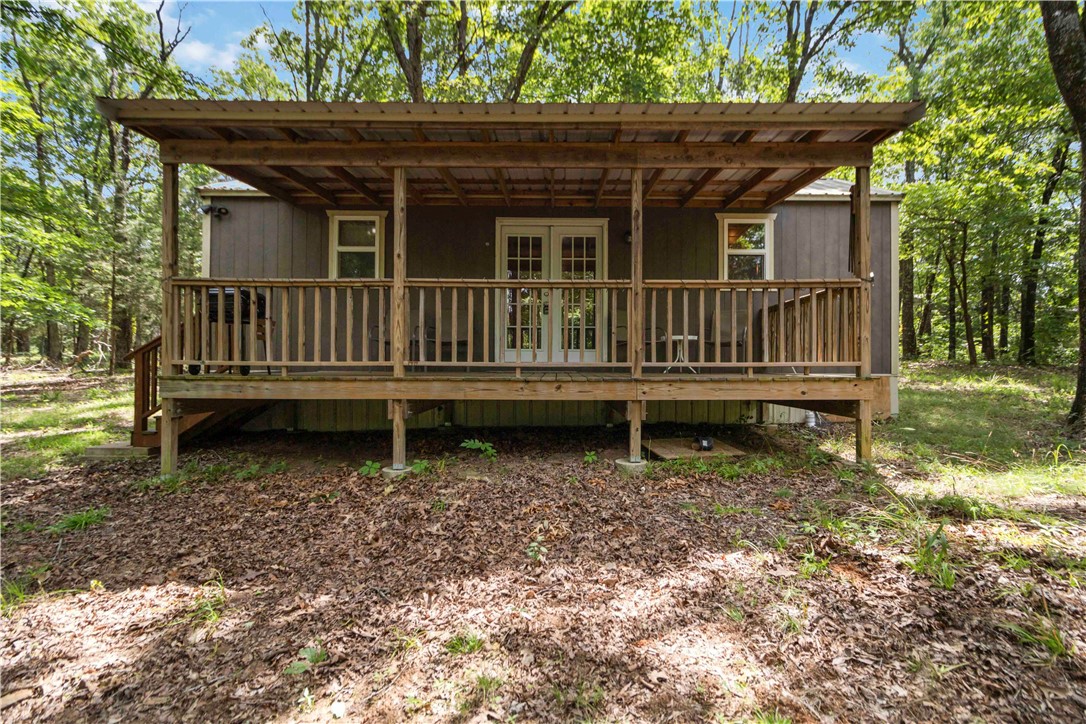 Tucked away on 2.07 peaceful acres along Bug Scuffle Road in West Fork, Arkansas, this charming tiny home offers the perfect blend of comfort and seclusion. Just minutes from the natural beauty of Devil's Den State Park, this all-electric retreat features a cozy bedroom, full bathroom, efficient kitchen, and a welcoming living room. Enjoy quiet mornings or evening relaxation on the covered front porch, surrounded by woods and wildlife. With public water service and internet access already in place, this property is ready for full-time living, weekend getaways, or a short-term rental opportunity in a serene Ozark setting. All items in the house convey.
