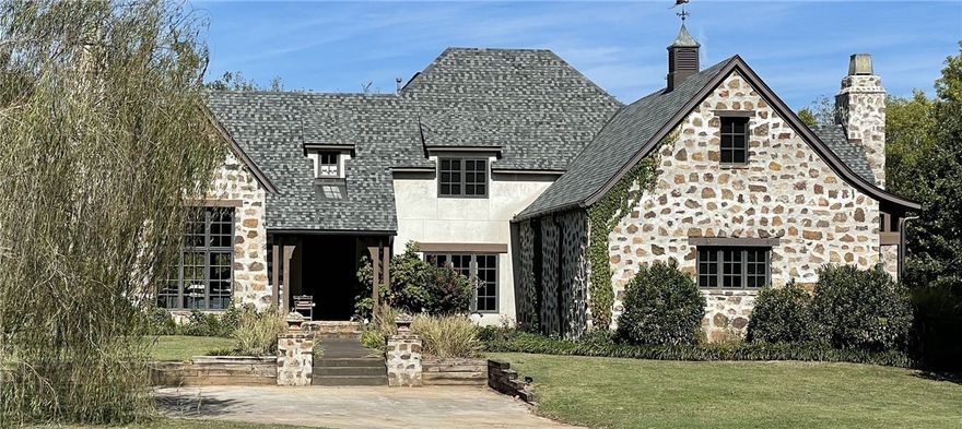 BENTONVILLE SCHOOLS!! Country Setting!! This beautiful European style, custom  Architect home sits on 3 acres with a year round creek, fish, kayak or tube in your back yard! Old world quality and charm throughout. Real hand crafted beams, two wood burning full masonry fireplaces, one pre cast and one dry stacked full stone, natural slate & stone flooring and hand planed wood floors show off the distinct character of the home. Enjoy the seasons in this park like setting. New roof in September 2021. Convenient central location, 20 mins to everywhere in NWA.