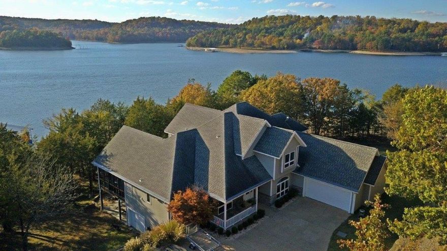 Custom built lake front home with community boat slip with lift and over 320' of your very own shoreline. 2.16 acres, 5377 SF,  4 bedroom, 3.5 baths. Dining room, office and exercise room, sunroom, computer loft with built in desk & custom cabinets. Gourmet kitchen with custom cabinets, Corian countertops, double ovens, warming tray, butler's pantry, center island, large breakfast bar. Durrango hardwood throughout. Wet bar off large game room. Heated/cooled garage downstairs. Screened in deck. Home is located in a gated community.