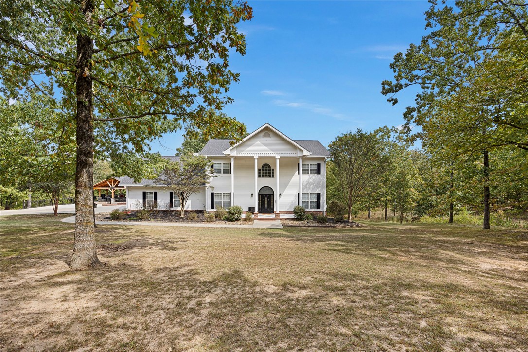 Nestled in the serene foothills of the Ozark Mountains, this expansive 5-bedroom, 3 full bathroom, 2 half bathroom home offers over 5,500 square feet of luxurious living space on 10 peaceful acres. Designed with comfort and functionality in mind, this three-story retreat balances generous space both indoors and out.On the main level, you'll find an open, chef-inspired kitchen equipped with a Kenmore Pro range, double oven, built-in fridge, custom cabinetry, and walk-in pantry--perfect for all your culinary creations. The main floor also includes the primary bedroom, laundry room, a cozy den, dining area, and a convenient half bath for guests.