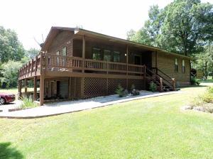 Nice cedar exterior home sitting on top of a hill with an awesome view. 10 acres with very private setting, just off the pavement. 2x6 walls. Well insulated. Kitchen has breakfast bar and lots of cabinets. Walk-in closet in master bedroom. Full unfinished, heated and cooled basement with garage door. The home has a lot of windows and a wrap-around porch and deck. Pasture, Woods, Pond, Outbuildings, Garden Spot, Orchard with Pears, Peaches, Apples and Plums. Privacy and a beautiful view with a tree-shaded setting awaits you.