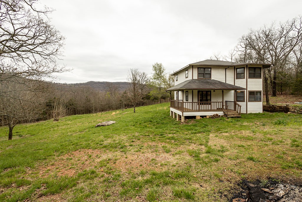 The quiet life awaits you here in the hills of Madison County. Two gently sloping, cleared and wooded acres to call your own. Add a couple of goats, a mess of chickens, a huge garden, and live your best country life. No idea how to milk a goat, shave a chicken, or root a bega? Then just consider this your respite at the end of work days in the city. Both Fayetteville and Huntsville are about 30 minutes west and east respectively. The home, perched near the top of the clearing, offers year round views as you relax on the porch, but the woods surrounding the property create sublime privacy and seclusion. And updates in the house have already been started for you, with downstairs HVAC (2015), a new water heater (2019), plus new blinds, vinyl plank flooring, interior paint, and downstairs bathroom vanity, sink and mirror, and upstairs HVAC all within the last year or so. Come in and place your finishing touches and start living the life you've been dreaming of.