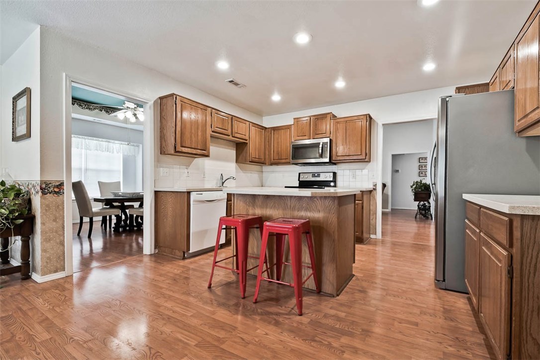 Fabulous find close to the interstate and shopping. Kitchen features great cabinets and counter space, island and eating area with benched bay window. French doors exit to deck and landscaped back yard. A formal dining room that can be used for many other purposes opens to a spacious living room with gas starter, wood burning fireplace. All floors are tile or laminate, bedrooms replaced 2017. New heat/air, kitchen counters (quartz), disposal, microwave & dishwasher newer (2017). See attached for more.