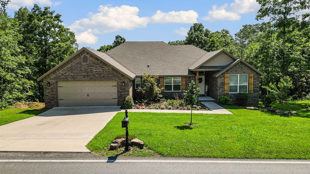 Built in 2022, this beautifully designed 3-bedroom, 2-bath home offers 2,032 sq ft of stylish living in a sought-after Bella Vista location, just minutes from Lake Loch Lomond. Enjoy nearby outdoor recreation with Tiree Park, boat ramp, and the Highlands Golf Course close by. The split floor plan features hardwood and tile throughout, blending durability and style. The spacious primary suite includes dual vanities, a soaking tub, and a large walk-in closet with direct access to the laundry room. The guest bath also features dual vanities. The open-concept eat-in kitchen flows into the living area, ideal for entertaining, while a formal dining room is perfect for gatherings. The beautifully landscaped yard includes a fenced backyard and covered porch, great for relaxing or hosting. Upgrades include modern light fixtures, ceiling fans, and an upgraded kitchen faucet.