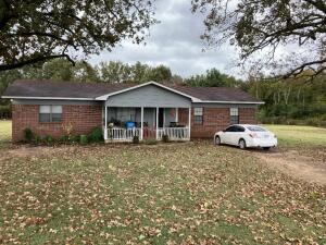 Large trees, garden area, brick home paved road, good area, large front covered porch, detached garage included, wood deck, 720 sq. ft. garage detached. good exterior paint on trim, rural wave high speed included, Insulated windows, vinyl plank flooring, nice kitchen has small bar, oak with small glass front cabinets, 2'' blinds, nice 3' X 4' walk in tile shower and whirlpool tub. New fencing, new lateral line on septic, has a pond.