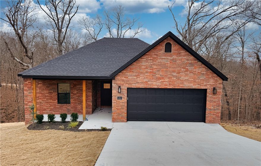 Outstanding location for stunning new Bella Vista home in peaceful, treed setting that feels secluded yet connected—just minutes to Downtown Bentonville, farmers market, restaurants, Coler Mountain Bike Preserve, Tanyard Creek Trail, & Branchwood Rec Center. Blending classic curb appeal with fresh, modern interior, this home offers 3 beds/2 baths & a bright open layout with quartz surfaces & luxury vinyl plank flooring throughout, plus kitchen island, stainless steel appliances, walk-in pantry, & dining nook. Thoughtful features include curated lighting, walk-in closet, laundry room, recirculating hot water, & bonus crawlspace storage perfect for bikes or outdoor equipment. Relax on the covered porch or back deck or on a child-friendly cul-de-sac, or enjoy Bella Vista’s amenities—golf, biking trails, a indoor & outdoor pools, & pickleball. Comes with a 2-year builder warranty. Use preferred lender to receive $3,500 for closing costs or prepaids.