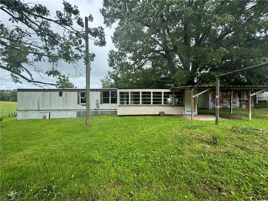 Investment Opportunity-SOLD AS IS!  2 bedrooms, 1 bathroom mobile that includes a pole barn and is conveniently located right off Hwy 412. Broker Owned. Agent related to seller. No repairs/No sellers disclosure. Priced to sell