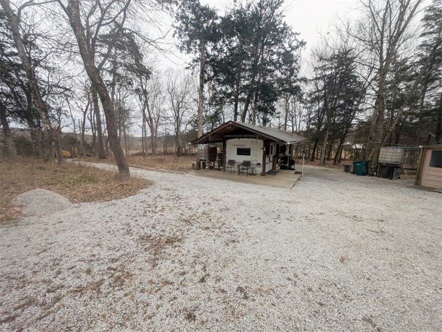 This 2.36 acres, m/l, in Valley Springs School District has no restrictions, a 1997 Fleetwood Euroway Model 27 camper (with title in hand), as well as a semi trailer (no title) finished out with a workshop area & small living quarters complete with bathroom & 2 beds.  Property has running water via rain collection system.  There is no rural water available & no septic installed.