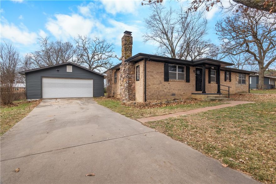 Charming home located in the heart of Gentry! This refreshed single-level home has 3 bedrooms, 2 baths, and an additional room that can be used for a sunroom, workout area, office, or second living space. This property features several recent updates, including a remodeled kitchen, an updated bathroom, new carpet in the primary bedroom, new flooring throughout the home, and new gutters, all within the last 5 years. System improvements include a sewer line replacement in 2023 and new HVAC. Situated with access to local amenities, schools, and highways.