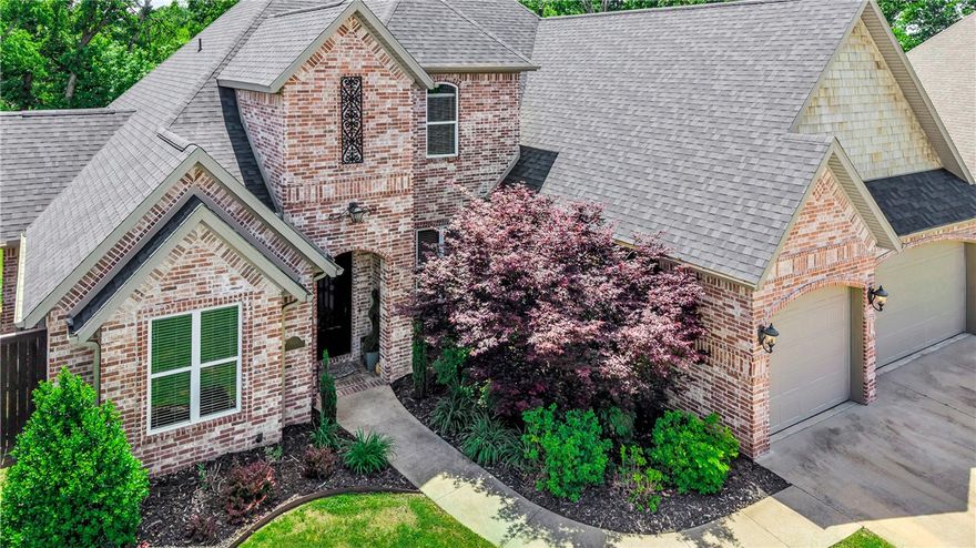 Imagine mornings picking fresh fruit from your own cherry, apple, or pear trees before walking to the community pool. Located in a quiet cul-de-sac close to downtown Bentonville and the new WalMart campus, this stunning 5-bedroom, 4.5-bath retreat offers the perfect blend of comfort and intentional living — a main-level primary suite for effortless everyday life, a home office, a bonus media room for family movie nights, and a covered patio with a brick firepit made for lingering evenings outdoors. Beautiful built-ins, a gas fireplace, and warm wood floors set the tone inside, while mature trees and full front-to-back irrigation complete the picture outside. Recent updates include a new roof, garage doors, and water heater (2024), carpet, upstairs paint, and microwave (2025), exterior lighting (2026), plus a new dishwasher and refrigerator that conveys — meaning you simply unpack and start living. Walkable trails, a playground, pavilion, and basketball courts round out this lifestyle-first community perfectly.