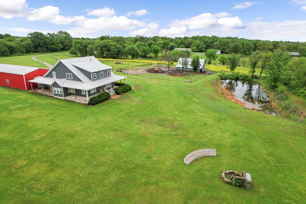 Just 7.5 miles from XNA Airport and 14.2 miles from the Walmart Home Office, this incredible 4-bed, 3.5-bath custom home on 20.12 acres offers 3,886 sq ft of exceptional living space. From the custom gated entrance to the nearly full wrap-around porch, you’ll be captivated by breathtaking sunset views and the tranquility of the countryside. Inside, enjoy the warmth of a wood-burning stove and the convenience of a central vacuum system. The spacious pantry doubles as a storm shelter/panic room for peace of mind.
Step outside to entertain with ease, featuring a piped propane hookup, a custom firepit, and a serene stock pond. The property also includes a 1,920 sq ft insulated shop with a wood-burning stove and 50 Amp welder/generator hookup, plus a separate antique gambrel-style barn with hay loft for added charm and versatility.
This one-of-a-kind property blends comfort, utility, and country charm.
There is an additional 10 acres of land available for purchase.