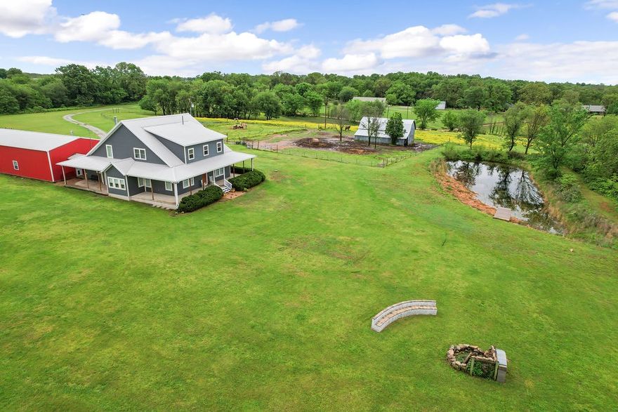 Just 7.5 miles from XNA Airport and 14.2 miles from the Walmart Home Office, this incredible 4-bed, 3.5-bath custom home on 20.12 acres offers 3,886 sq ft of exceptional living space. From the custom gated entrance to the nearly full wrap-around porch, you’ll be captivated by breathtaking sunset views and the tranquility of the countryside. Inside, enjoy the warmth of a wood-burning stove and the convenience of a central vacuum system. The spacious pantry doubles as a storm shelter/panic room for peace of mind.

Step outside to entertain with ease, featuring a piped propane hookup, a custom firepit, and a serene stock pond. The property also includes a 1,920 sq ft insulated shop with a wood-burning stove and 50 Amp welder/generator hookup, plus a separate antique gambrel-style barn with hay loft for added charm and versatility.
This one-of-a-kind property blends comfort, utility, and country charm.
There is an additional 10 acres of land available for purchase.