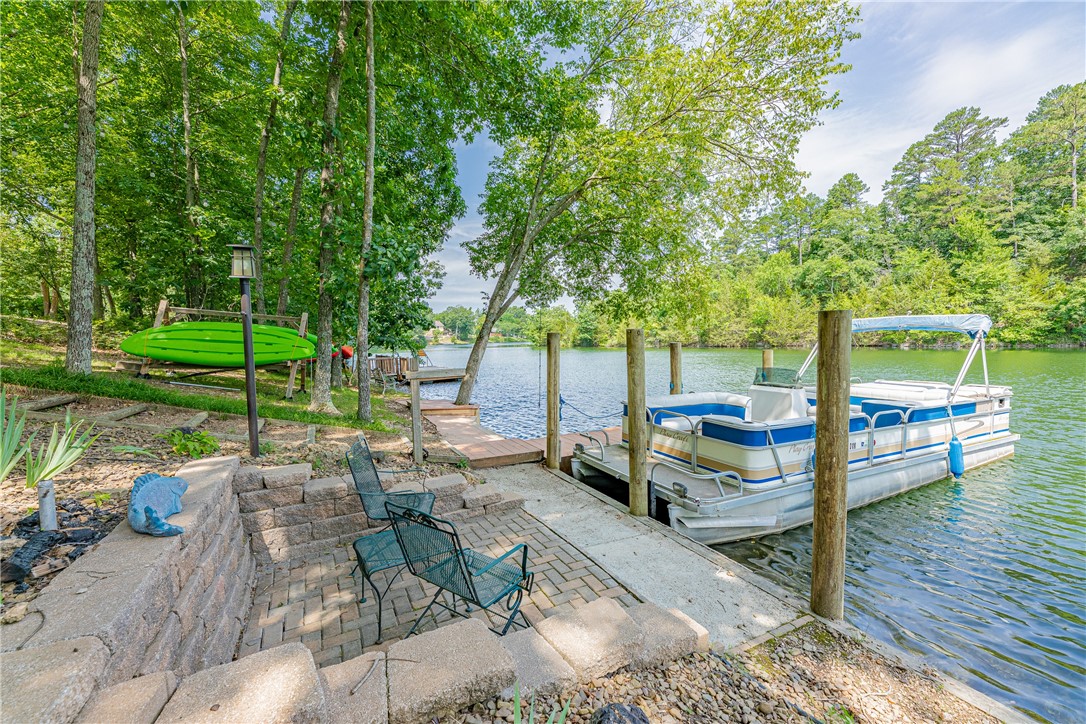 Yes, you CAN live the dream~ Effortless access to the lovely and tranquil Lake Rayburn. 132ft. of Lake Frontage. Have fun like you're on vacay every day & night, and the sensational sunsets are free! Huge rooms, great closets, super storage. Experience the Man Cave in this rock solid home for yourself! 2020 Dual Fuel HVAC, 2021 HW heater, tremendous brand new concrete patio and steps lead to a lovely natural stone terrace and firepit to enjoy on chilly nights with friends & family. Native stone fireplace with robust insert in the spacious Living Room and a built-in electric fireplace with thermostat downstairs. Here you'll find the greatest backyard with the coolest swingset, horse shoe pits, Kayak rack, a waterside seating space, and the fabulous concrete walkway at the water's edge makes fishing easy. Steps even lead right into the water! There's also a rope swing over the lake and 3 ricks of firewood convey at no charge! Timed garden lighting, 4 Motion lights & a Ring Doorbell for your safety. Gutter guards too