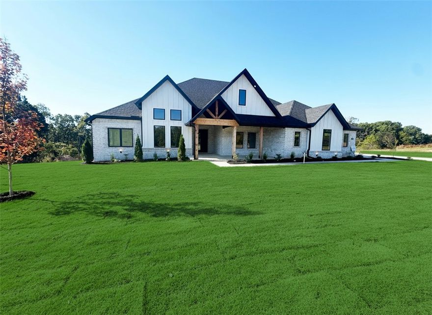 Located in Serenity Ridge, NWA's newest gated luxury subdivision, this beautifully designed 2-story home sits on a spacious 1-acre lot and offers the perfect blend of luxury and comfort. Featuring 5 bedrooms, 4 bathrooms, and a dedicated office, this home is ideal for both entertaining and everyday living. The kitchen boasts quartz countertops, custom cabinetry, and upgraded stainless steel appliances. Enjoy year-round outdoor living on the covered back patio with a brick fireplace and gas logs. Additional features include a welcoming front porch and thoughtfully selected finishes throughout.  Taxes based on land only. Builder is offering $15,000 in concessions. Estimated completion date is mid November.