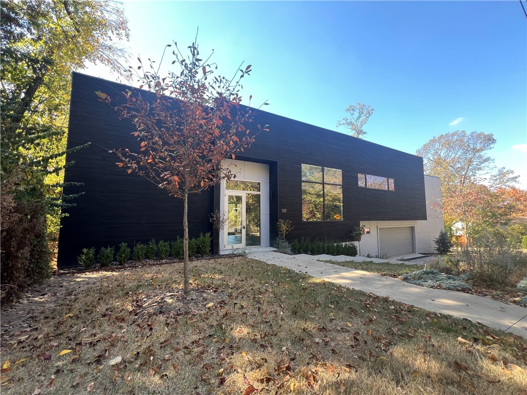 Discover the epitome of contemporary living in this stunning architectural masterpiece located on the prestigious Mount Sequoyah. This 3 bed, 2.5 bath residence seamlessly blends cutting-edge design with luxurious comfort. A triumph of modern design, this home stands as a testament to the marriage of form and function. Clean lines, expansive glass walls, and a minimalist aesthetic create a captivating visual experience. The state-of-the-art kitchen is a culinary haven, featuring top-of-the-line appliances, sleek cabinetry, and an oversized island that doubles as a gathering point for friends and family. The master bedroom is a private retreat offering a tranquil space to unwind. The ensuite bathroom is a spa-like sanctuary, complete with a soaking tub, dual vanities, and a walk-in rain shower. Outside you will find an inviting deck with composite decking with wire railing. The construction of this home is like no other with Shou Sugi Ban (charred wood siding), TPO roofing material and spray foam insulation.
