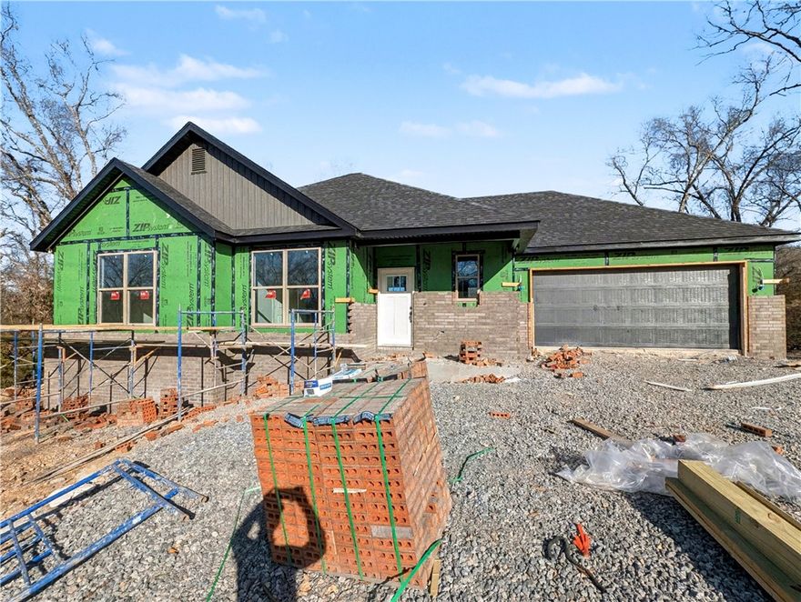 Welcome To Your Next Home! This Brand-New Build Packs Style, Space, And That “Let’s Make Life Easy” Energy. Bentonville Schools. Sitting In A Killer Spot With Mountain Bike Trails Close By, You’re Set Up For Instant Adventure And Everyday Convenience. Step Into A Bright, Airy Layout Featuring A Vaulted Living Room, Bold Beam Accents, A Warm Fireplace, And A Kitchen That Shows Off—Custom Cabinets, Quartz Counters, Tile Backsplash, Island Seating, And A Walk-In Pantry Ready For All The Snacks. The Primary Suite Brings The Retreat Vibes With A Full Custom Tile Shower, Dual Vanity, And A Closet Built For Real-Life Storage Wins. 2 Secondary Bedrooms Give You Options. Full Hall Bath. Head Out Back To A Covered Deck That Looks Over A Calm, Wooded Backyard—Perfect For Coffee, Chill Time, Or Post-Ride Recovery. Thoughtful Upgrades, A Smart Floorplan, And A Location That Just Works. This One Feels Good The Second You Walk In! Still Time To Make Interior Selections.