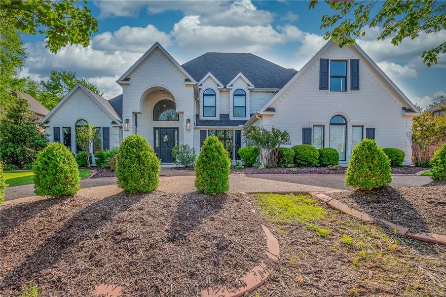 Located in gated Pinnacle Country Club, this 4,424 sq ft transitional home sits on a private half-acre lot & is fully renovated & move-in ready. The main level includes formal dining, living room, eat-in kitchen with adjoining family room, office with fireplace &  primary suite with fireplace. The renovated primary bathroom features dual sinks, soaking tub, large walk-in shower & dual walk-in closets. Upstairs includes 3 bedrooms, 2 full bathrooms, bonus room & newly added game room. Recent updates include new countertops throughout, full interior and exterior paint, updated lighting, roller screen in office, new windows, new exterior lighting, extended patio with outdoor fireplace + retractable screens & a backyard perimeter mosquito misting system. Outdoor living overlooks a private backyard with pool & spillover waterfalls. Rare 5 car garage, circle drive, whole-house generator, whole-house air & water filtration & storm shelter in garage. Convenient to I-49, Walmart AMP, hospitals, shopping, dining, and trails.