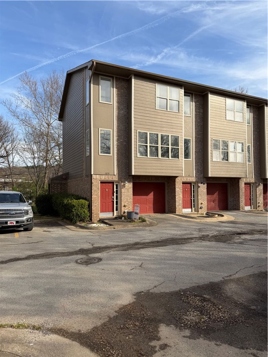Welcome home to this well-located condo just minutes from the University of Arkansas and all things Fayetteville. Step outside your door and hop directly onto the Razorback Greenway located behind the property—perfect for morning runs, bike rides, or an easy connection to campus and downtown. Inside, the home features durable vinyl flooring, 3 bedrooms, 2 full bathrooms, and a convenient half bath, offering a functional layout for everyday living or rental use. A private one-car garage adds valuable storage and parking convenience. This property has operated as a VRBO for over three years, making it an excellent option for investors, students, or anyone seeking a low-maintenance lifestyle close to the U of A. Any furnishings may be negotiable for purchase, & the refrigerator, washer, & dryer may convey with an acceptable offer. May qualify for FHA or other loan options, subject to lender approval.