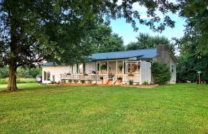 Welcome to your new oasis! This beautiful ranch style home is located just 5 min. from town, in a gorgeous setting w/absolutely STUNNING views! Sit on your front porch & watch the most AMAZING sunsets disappear behind the green rolling hills. On 1 ac. & boasts a lg. front porch & deck surrounded by beautiful landscaping, w/brand new flooring, freshly painted walls & is move-in ready! You will love the lg. bright kitchen w/tons & tons of cabinets & counter space, a new microwave & DW. Home has a wood burning FP in the LR & a huge family room w/11' ceilings, crown molding, & beautiful engineered HW floors. The MBR has his & her closets & the MBA has double sinks, tile floors, & granite countertop. Includes storage sheds & lg. mature trees. Bergman Schools. This house will not last long!
