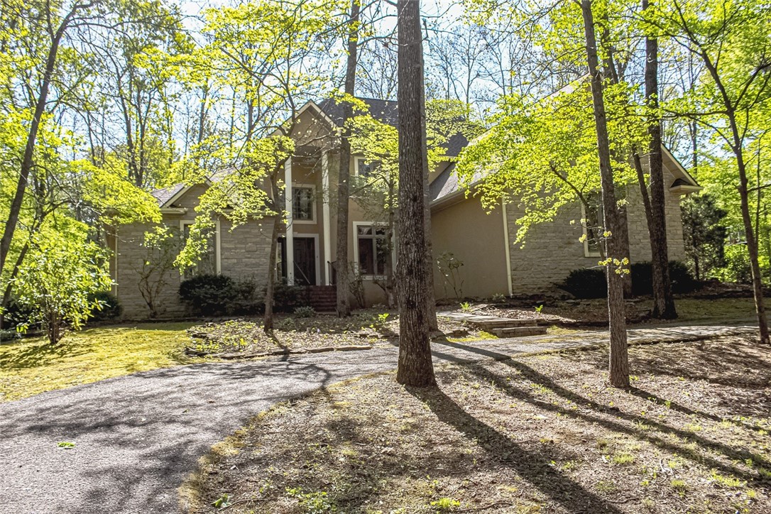 This is a beautiful 2 story home with a basement, 5 spacious bedrooms, six bathrooms & 3 car garage. It features cathedral ceilings, hardwood floors, Corian countertops, 2 fireplaces, and large walk-in closets. Then basement could serve as a mother-in-law suite with its own kitchen, living area and separate entrance with its own garage. The home's location on a wooded 1 ac lot with dogwoods and a large backyard with hot tub, chargrills, smoker and fire pit is perfect for outdoor relaxation and entertainment. Come check out this home located in one of Harrison's most desirable neighborhoods. Sounds like a perfect place to call home!