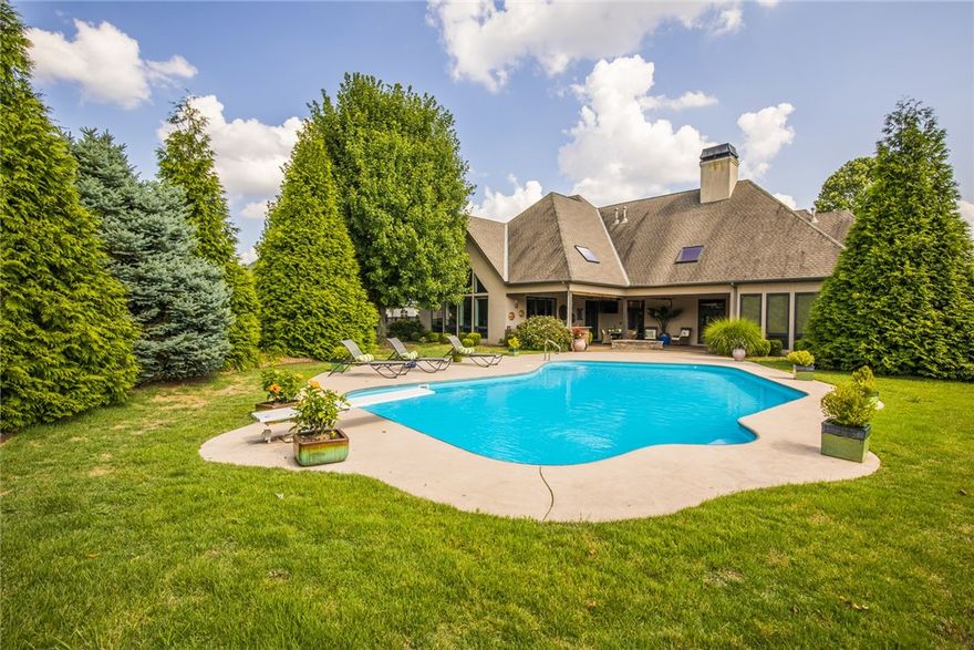 Beautiful custom contemporary home in a gated subdivision. This home has all the bells and whistles while being close to everything. All living areas are on the main level while all the bonus areas are upstairs, bonus room, office, exercise room, ideas are limitless. This elegant home was made for entertaining! The Huge gourmet kitchen connects to the hearth room, and the stunning dining and living rooms, which lead to your backyard oasis. This fabulous setting and custom covered patio are a must see. The covered patio has sky lights, built in grill, fridge, stained concrete, professional landscaping and a refreshing inground private pool all in your own backyard. New roof going on now!