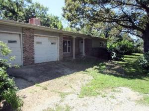 You will love the low maintenance exterior of this 3 bedroom 1 1/2 bath home boasting large living room, fireplace, sunroom, storage shed & 2 car garage. Brick/Stone & Vinyl exterior with metal roof. All #'s are approx., age is estimate, sq. footage per assessor, buyer to verify existence of septic.This property has been placed in an auction event. All offers should be submitted on www.realtybid.com. All offers received while in auction should be placed by the buyer or buyer's agent in the form of a bid, by clicking on the ''Bid Now'' button, if available, on the Property Details page. Contact RealtyBid Customer Service at 877-518-5700 or CustomerService@RealtyBid.com for bidding assistance or to obtain bidder auction terms.''