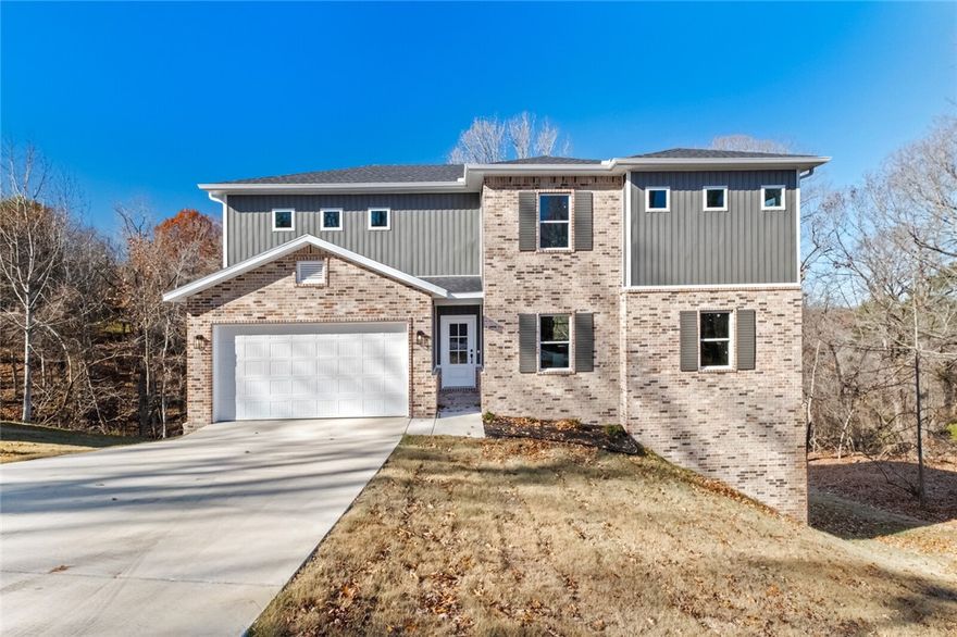 Ready to be away from the hustle and bustle but also close enough to all things NWA? Check out this Gorgeous New Construction with open concept living space and kitchen that has a large
island that is perfect for the heart of the home.  This home is 2 bedrooms with an additional room for an office/guest room, 2.5 baths, a bonus loft area and 2 covered decks surrounded by nature. Natural light funnels through the windows to light up the home. The Primary En Suit has a Custom Tile Shower and Free-Standing Tub that is perfect for relaxing after a day on the lake. 2nd story laundry this is convenient to the bedrooms. This home is perfect for a family and entertaining guests. A few short minutes away from Beaver Lake and only 10 minutes from Downtown Rogers. The home is on a 2 bedroom septic system.