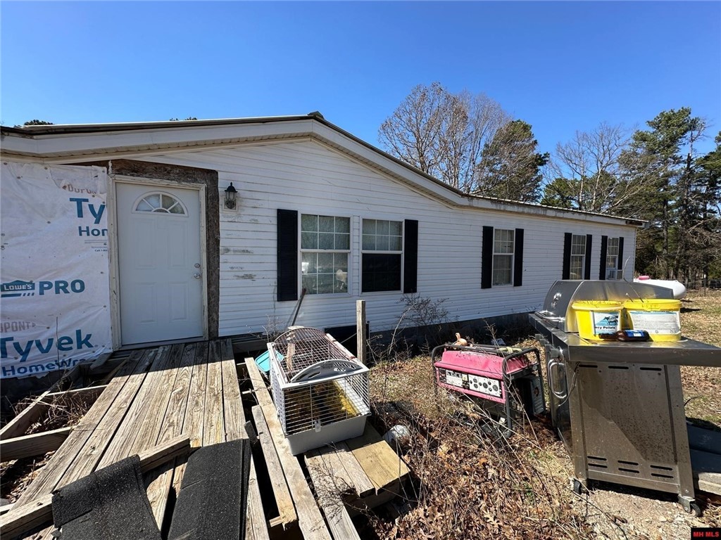 Mini-Farm & Homestead Opportunity-13.71 acres m/l near Yellville, AR! Looking for a peaceful country retreat with room to grow? This double-wide mobile home sits on 13.71 acres m/l of fenced land, offering the perfect setup for a mini-farm or homestead. Whether you dream of raising goats, cows, horses, or chickens, this property is already equipped with study fencing, a pond for livestock, and multiple lean-tos for shelter. Envision the possibilities! The sub-floors have been completely redone, & some building materials are included, giving you a blank canvas to customize the space to your needs. A cozy country getaway or a full-time homestead, this home is ready for your finishing touches. Property comes with electric & shared well. Nestled in the rolling Ozark hills with beautiful views open pastureland and short drive from Yellville.
