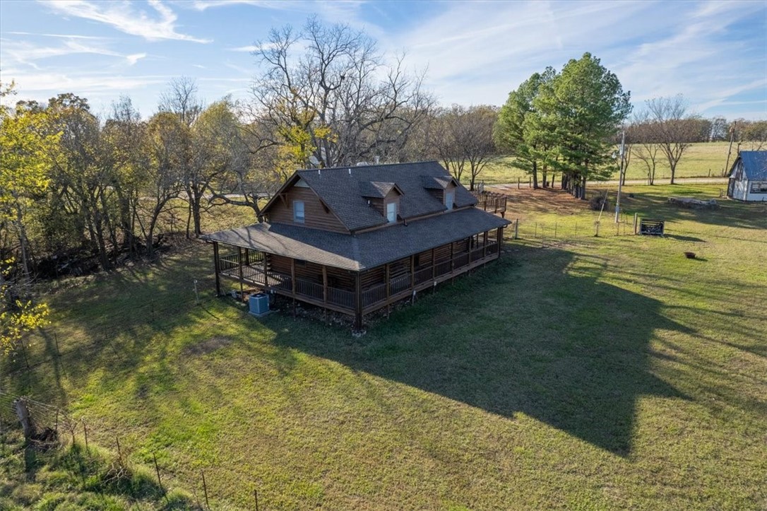 Find your slice of paradise in this 3-bedroom, 2-bath log cabin on 3.48 serene acres! This home boasts a wraparound porch, a cozy living room with a wood-burning stove, and a primary bedroom with private deck access. The outdoor space is just as inviting, with mature trees, open pasture, and a peaceful country setting. High-speed fiber internet and public water ensure comfort without sacrificing seclusion. Minutes from Siloam Springs and a short drive to Fayetteville!. This is the ideal home for those who love nature and peaceful living.