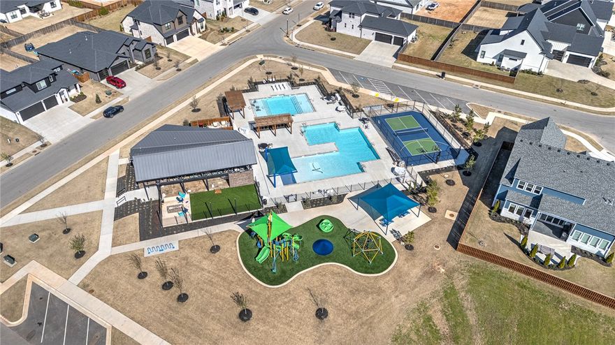 Luxurious finishes throughout this 4BR, 3.5bath home with private office. The heart of the home features a show-stopping kitchen with an arched island, waterfall quartz countertops, and premium GE Café appliances, including a 48" gas range. A massive walk-in pantry and hardwood floors add both function and style throughout the main living areas. Light-filled family RM opens effortlessly to a covered back patio through folding glass doors creating a true indoor-outdoor experience surrounded by trees & brand-new fescue sod. The primary suite is a private retreat, offering, a freestanding vessel tub, and a spa-like shower with dual shower heads. Remote-controlled window coverings create ideal sleep conditions. Curb appeal unmatched, designer concrete driveway & side-load garage. Located just steps from neighborhood amenities, including resort-style pools, splash pad, open-air clubhouse, sports court, playground, dog wash station, and bike repair station this home perfectly blends luxury with an active lifestyle