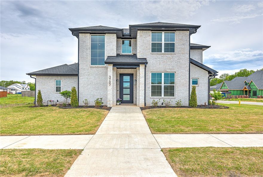 AURORA SHOWSTOPPER!! Nestled on a corner lot in one of NWA’s most sought after communities, this BETTER THAN NEW 4 bed/3 bath home offers a fabulous floor plan featuring a luxurious primary suite and a guest bedroom both on the main level!  Walk into an open and spacious main living area filled with natural light and plenty of space to entertain! The living room features custom beams, tiled linear fireplace and glass doors that open to a covered patio that has been extended to accommodate all your outdoor living needs!  The chef’s kitchen is sure to WOW with its oversized island with bar seating, stainless appliances including gas cooktop & double ovens, and a massive walk-in pantry!  Second level hosts 2 gracious secondary bedrooms w/ walk-in closets, a huge bonus room and a full bath!  Side load 3 car garage & mud room w/ custom built-ins!  TONS of community amenities: Adult pool, family pool, splash pad, bike repair station, dog wash station, elevate fitness course, sports court open air clubhouse & playground!