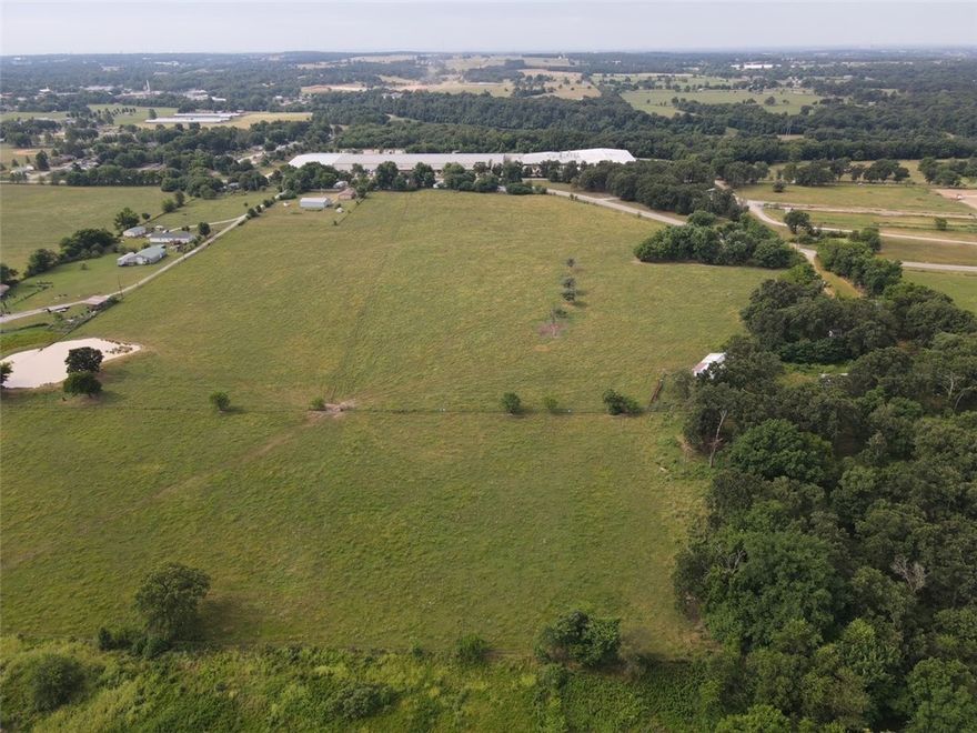 33.65 acres of open ready for development land. Water and sewer at street. Perfect setting for a nice subdivision. Outbuildings are a bonus and mobile will be removed. This is a perfect opportunity on a growing area.