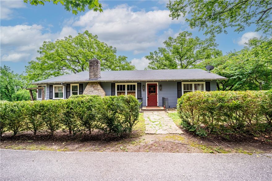 2 homes and 9 acres M/L of beautiful woodland on a ridge in the heart of Eureka Springs AR. Destiny Farm is one of the last large parcels of green space within a few minutes' walk of downtown. This idyllic setting of blossoming dogwoods and redwoods in the spring and maples in the fall, located between Main and Benton Streets, is appearing on the market for the first time in forty years, offering a rare opportunity to own one of the most desirable properties in Eureka Springs. Formerly, the Ozark retreat of Irene Castle, world-famous dancer and fashion icon of the early twentieth century. Destiny farm once hosted such luminaries of the stage and screen as Helen Hayes. the two bed, 3 bath main house is distinguished by its cozy, pine-paneled living room and stone fireplace. On the eastern side of the house bathed in morning light is an enclosed porch overlooking the yard and on the southern side is a large sun room bordering the edge of the woods.