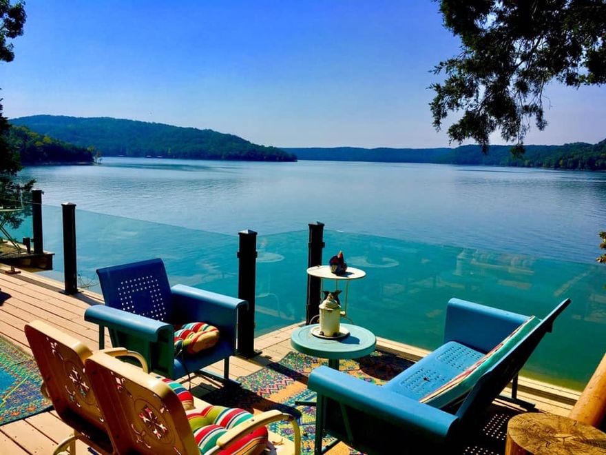 THE ULTIMATE IN LAKEFRONT LIVING!!  This gorgeous lakeside Canadian log retreat enjoys STUNNING open vistas of Beaver Lake.  Enjoy your own private beach front setting with gentle walk to lake and community boat dock w/boat slip & lift! This turn-key property boasts 2 levels of decking with new glass paneled railing for completely unobstructed views!  3 level interior features lots of updates and spectacular open living room with 30’ ceilings, wood burning fireplace and floor to ceiling windows! Beautiful chef’s kitchen, main level master suite w/deck access, charming sunroom perfect for taking in the one-of-a-kind views!  Second living quarters is featured in the walk-out basement complete with full kitchen, living w/fireplace, 2 bedrooms, full bath, storage and more…great for hosting.  Beautiful new Hickory wood flooring, whole house generator, maintenance free exterior, new light fixtures & paint…all in one of the most beautiful spots on the lake w/gorgeous cliffs & waterfalls right in your own backyard!!