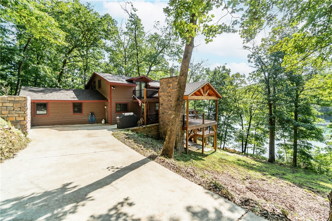 Welcome to your own private lake front oasis with a 3 slip boat dock! This fully renovated home offers something for everyone, including two masters - one on the main level and a second in the loft - plus two more bedrooms downstairs with a 2nd living space that can be used as an additional bunk-room. Enjoy stunning cathedral ceilings with wood planking and floor-to-ceiling windows in the main living area, or lounge out on the expansive outdoor patio complete with an outside fireplace and plenty of sitting space. Plus, you'll have your own 3 slip private boat dock right at your fingertips! This home has been taken down to its studs for a full remodel, featuring all new roofing, windows, siding HVAC systems, water heaters and decks. Kitchen is equipped with a Bertazzoni gas rangeWith over one acre of land included, you'll have plenty of room to enjoy all that Beaver Lake has to offer. Donāt miss out on making this your very own lakefront retreat!