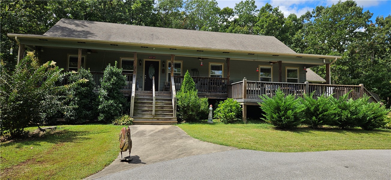 Welcome to your own little piece of paradise. 3-bedroom 2 bath custom built home nestled in the middle of 17+ acres within city limits. Has a large open front porch and screened back porch. Vaulted ceilings and hardwood floors. Whole house generator with a 500-gallon inground propane tank. RV hookup and carport. Chicken coop, greenhouse, additional single car carport and storage buildings all convey. Only 13 minutes to Centerton and 26 minutes to Walmart Corporate. Possibility for development. You don't want to miss this one.