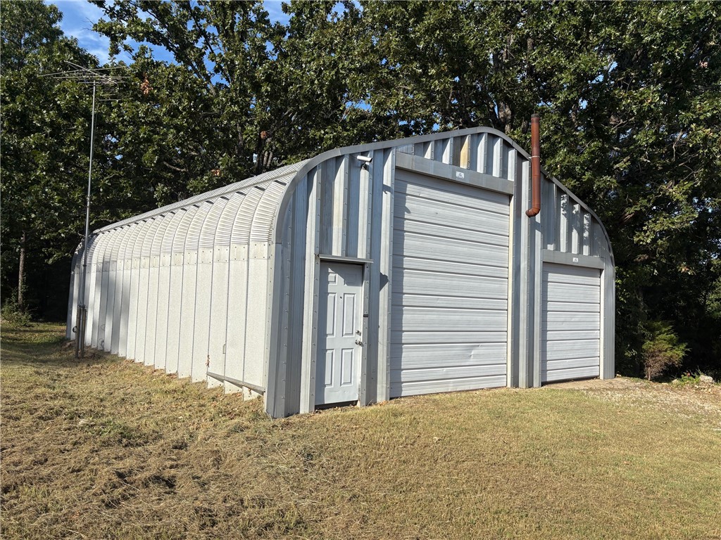 Three great lots, one with many improvements, very near Kings River public access, destination city Eureka Springs and less than an hour to Branson. Very busy Hwy 62 frontage on two lots, private homebuilding spot behind and off highway. Water is a shared community well with actual well on neighbors. There is a well agreement in place on covenants. So many possibilities with this property...2 full RV hookups, lots of storage and extra double garage plus the huge metal building with living quarters inside. Nightly rental set up?? , lots of room to build anything you want with gas available and water to each lot. Built in 2010, main building in great shape. Highway frontage on 2 lots, private access back to rear lot. 4.07 acres total...can be secluded or out on busy highway for exposure. Possibilities are endless...