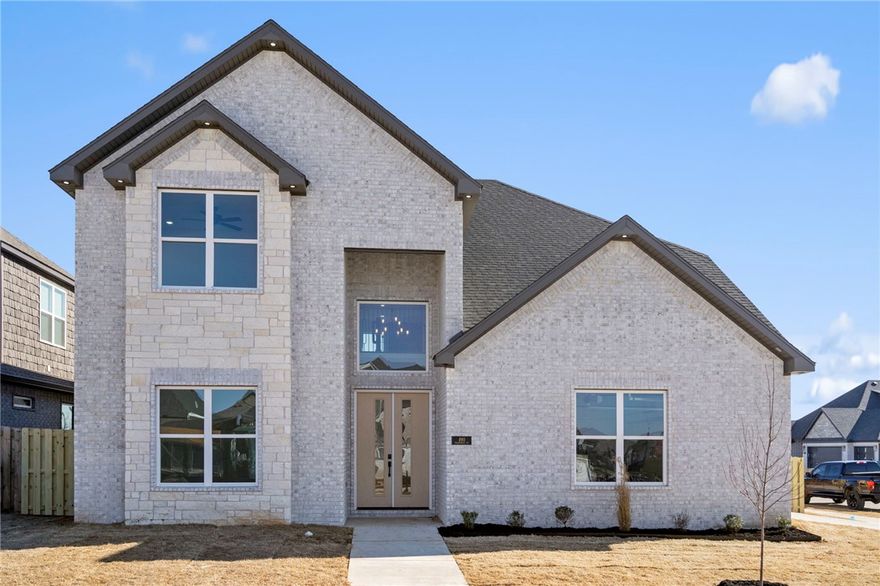 Stunning New Construction | Modern Luxury Meets Timeless Craftsmanship- Soaring two-story ceilings and an open-concept layout set the stage in this breathtaking new build. The dramatic great room features a sleek linear fireplace framed by a floor-to-ceiling shiplap accent wall, flooding the space with natural light. The chef's kitchen impresses with custom walnut-toned cabinetry, quartz countertops, arabesque tile backsplash, double oven, and a center island with wine rack and matte black fixtures. Gold hardware accents add a refined touch throughout. A designer taupe accent wall anchors the dining area, while a wrought iron staircase, floating shelves, and built-in bar console elevate the main living space. The spa-inspired primary shower showcases large-format charcoal tile, hex mosaic flooring, and a built-in bench. Secondary baths carry the same upscale finishes. Every detail has been thoughtfully crafted — SELLER AND PREFERRED LENDER OFFERING UP TO $15,000 IN CONCESSIONS FOR CLOSING COSTS OR RATE BUY-DOWN