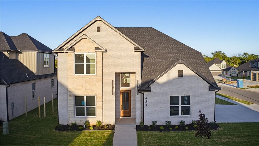 Stunning New Construction | Modern Luxury Meets Timeless Craftsmanship- Soaring two-story ceilings and an open-concept layout set the stage in this breathtaking new build. The dramatic great room features a sleek linear fireplace framed by a floor-to-ceiling shiplap accent wall, flooding the space with natural light. The chef's kitchen impresses with custom walnut-toned cabinetry, quartz countertops, arabesque tile backsplash, double oven, and a center island with wine rack and matte black fixtures. Gold hardware accents add a refined touch throughout. A designer taupe accent wall anchors the dining area, while a wrought iron staircase, floating shelves, and built-in bar console elevate the main living space. The spa-inspired primary shower showcases large-format charcoal tile, hex mosaic flooring, and a built-in bench. Secondary baths carry the same upscale finishes. Every detail has been thoughtfully crafted — SELLER AND PREFERRED LENDER OFFERING UP TO $15,000 IN CONCESSIONS FOR CLOSING COSTS OR RATE BUY-DOWN