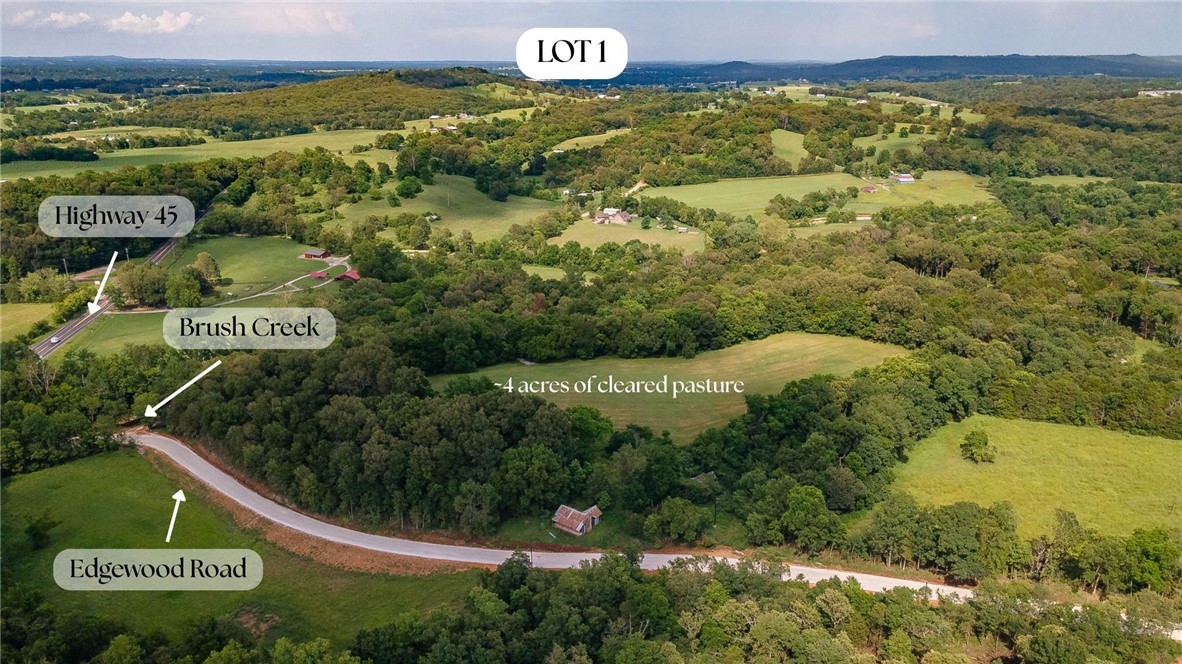 Incredible opportunity to own an estate style lot 15 minutes from the intersection of Crossover and Mission in East Fayetteville. Rolling hills, a private drive, mature trees, situated on a 12.24 acre lot of which 4 is a flat pasture! Utilities are available as well as a perc test. This is the perfect building site for an executive style home or a weekend retreat! Property is zoned for Fayetteville Schools.