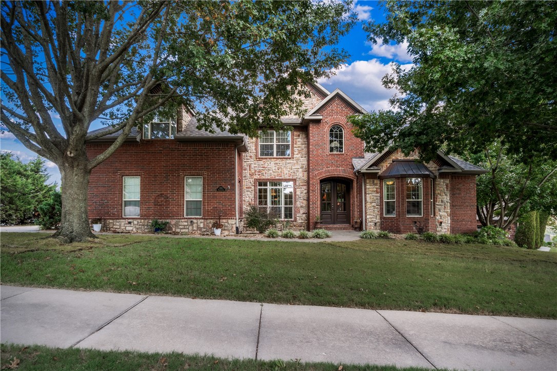 Experience timeless elegance in this traditional-style home in Windemere Woods, one of Bentonville's most desirable neighborhoods. Nestled on a .33-acre corner lot, this inviting residence blends refined design with modern comfort just 10 minutes from Downtown Bentonville and offers easy access to I-49 and US-71. Inside, enjoy lofty ceilings, hardwood floors, crown molding, built-ins, and two gas fireplaces within an open, flowing layout ideal for entertaining. The gourmet kitchen features granite countertops, stainless steel appliances, and a gas cooktop. A distinguished home office with French doors off the front entry, a flexible bonus room with tons of storage, and spacious main-level primary suite with deck access ensures peaceful living. Relax outdoors on the newly resurfaced deck overlooking a fenced backyard. With a 2-year-old roof, 3-car garage, and close proximity to Slaughter Pen Trail, Coler Park, and Bentonville Schools, this home offers luxury, style, comfort, and location.
