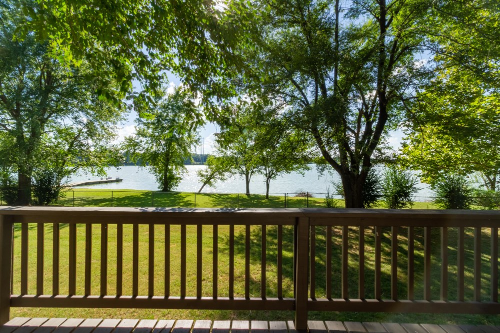 Welcome to this wonderfully quaint 3 bed/2 bath lakefront home on the bank of Lake Elmdale! Home is in close proximity to I-49. Walking in, you’ll notice vaulted ceilings, exposed beams, and large windows to enjoy the beautiful views this home has to offer! Living room includes a wood-burning stove creating a cozy atmosphere. Master suite features its own access to the deck with a lovely view of the lake. Laundry room has tons of cabinet space. And oversized 2 car garage attached by breezeway could serve as multiple purposes. Large back deck is the perfect place to relax and take in the scenery. Office/library off of master could also serve as another bedroom. The large trees surrounding the property provide ample amount of shade and privacy from the neighbors. 120 sq ft detached building could be used as a fishing shack or workshop! Trane HVAC system was installed in Dec. 2018. Come see your next home!