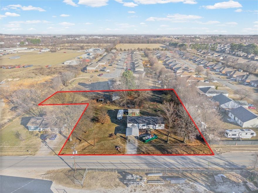 Investor Opportunity 1.5 Acres-Prime Springdale Location. Exceptional investment property in a high-traffic, high-growth area of Springdale, ideally located between downtown Springdale and I-49. This flat parcel is currently zoned residential but identified by the city as having commercial potential, offering strong future rezoning and development upside. With no HOA restrictions, this property allows for maximum flexibility, ideal for land banking, future commercial development, mixed-use potential, or a build-to-suit opportunity. The site offers excellent accessibility & visibility, making it attractive for retail, office, service-based businesses, or residential development (buyer to verify zoning and use). A mobile home and metal storage shed convey at no additional value, positioning the property as a value-driven land purchase with minimal improvement considerations. Opportunities like this—large acreage, prime location, rezoning potential, and no restrictions—are increasingly rare in Springdale.