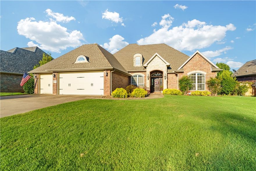 Beautifully landscaped 3-car garage home with a welcoming front seating area, located near top-rated schools, restaurants, and NWA favorites like Top Golf, Walmart AMP, and Pinnacle Hills Promenade—plus just a 2-minute bike ride to the Greenway Trail! Inside, the split floor plan features arched hallways, a butler’s pantry, tile flooring with carpeted bedrooms, and striking wood beams in both the living room and primary suite. Enjoy a cozy gas fireplace, formal dining, and a newly fenced backyard with an additional fenced side yard, paved walkway to a fire pit and seating area, and a covered deck with gated yard access. The deck connects to the kitchen, living room, and primary bedroom for seamless indoor-outdoor living. The primary suite offers a jetted tub, double vanity, walk-in closet, and private porch entry.-Roof 2021. HVAC 2025. Sellers offering $5K for carpet/paint allowance with acceptable offer.